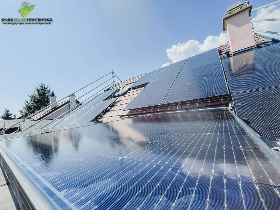 Panneaux solaires monocristallins entretenus sur une toiture en tuiles à Genève